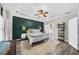 A Primary bedroom showcases a textured accent wall, tray ceiling and en suite bath at 2653 W Main Nw St, Atlanta, GA 30318
