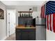 Convenient wet bar featuring a sink, cabinetry, mini-fridge, and shelving, ideal for entertaining guests with refreshments at 2653 W Main Nw St, Atlanta, GA 30318