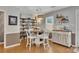 An eat-in dining area with laminate floors, a round table with white chairs, and an adjacent shelving unit at 289 Westland Sw Way, Marietta, GA 30064