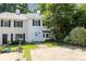 Well-manicured lawn with sidewalk leading up to this townhouse with mature landscaping, and a white front door at 289 Westland Sw Way, Marietta, GA 30064
