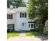 Charming two-story townhome with white siding, black shutters, and a well-maintained front yard at 289 Westland Sw Way, Marietta, GA 30064