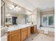 Bright bathroom featuring dual sinks, large mirrors, and a soaking tub at 4046 Newhaven Ne Cir, Atlanta, GA 30319
