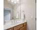 Bathroom with a white sink, wood cabinets, and a large mirror, reflecting the neutral-toned space at 4046 Newhaven Ne Cir, Atlanta, GA 30319