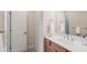Bathroom featuring a white sink, wood cabinets, and a doorway leading to another room at 4046 Newhaven Ne Cir, Atlanta, GA 30319