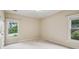 Bright and airy bedroom with neutral carpeting, two windows, and simple decor at 4046 Newhaven Ne Cir, Atlanta, GA 30319