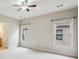 Spacious carpeted bedroom with two windows, ceiling fan, and a door leading to a bathroom at 4046 Newhaven Ne Cir, Atlanta, GA 30319