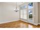 Bright dining area featuring a modern chandelier, large windows, and a patio door leading to the outdoors at 4046 Newhaven Ne Cir, Atlanta, GA 30319
