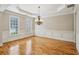 Bright dining room boasts hardwood floors, wainscoting detail, and a modern chandelier, creating an elegant space at 4046 Newhaven Ne Cir, Atlanta, GA 30319