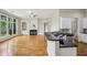 Spacious kitchen flows into living area with fireplace, boasting white cabinets, black counters, and hardwood floors at 4046 Newhaven Ne Cir, Atlanta, GA 30319
