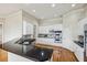 Modern kitchen featuring white cabinets, stainless steel appliances, black countertops, and ample storage space at 4046 Newhaven Ne Cir, Atlanta, GA 30319