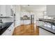 Gourmet kitchen featuring white cabinets, black countertops, stainless steel appliances, and gleaming hardwood floors at 4046 Newhaven Ne Cir, Atlanta, GA 30319