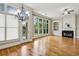Sunlit living room features a cozy fireplace, built-in bookshelves, and large windows offering serene backyard views at 4046 Newhaven Ne Cir, Atlanta, GA 30319