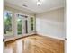 Versatile room with hardwood floors, natural light, and access to the outdoors via French doors at 4046 Newhaven Ne Cir, Atlanta, GA 30319
