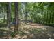 View of back of home with small deck and wooded back yard offering privacy at 539 Karen Dr, Alpharetta, GA 30009