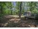 A backyard featuring a wooden deck and storage shed surrounded by mature trees at 539 Karen Dr, Alpharetta, GA 30009