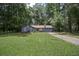 Charming single-story home with blue siding, red shutters, and a lush green lawn at 539 Karen Dr, Alpharetta, GA 30009