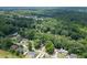 Expansive aerial shot capturing the neighborhood with tree coverage and suburban homes at 711 Belgrave Ln, Tucker, GA 30084