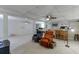 Partially finished basement featuring cozy seating, bar, and a ceiling fan at 711 Belgrave Ln, Tucker, GA 30084