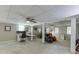 A fully finished basement with a ceiling fan, desk and workstation, and comfortable seating area at 711 Belgrave Ln, Tucker, GA 30084