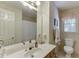 Traditional bathroom featuring a vanity, toilet, and framed mirror with floral wallpaper at 711 Belgrave Ln, Tucker, GA 30084