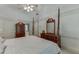 Primary bedroom features a four-poster bed, vaulted ceilings, and wood furniture at 711 Belgrave Ln, Tucker, GA 30084