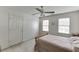 Bright, neutral bedroom with soft carpet, white walls, a ceiling fan, and natural light at 711 Belgrave Ln, Tucker, GA 30084
