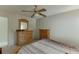 Neutral bedroom with carpet, ceiling fan, and two dressers offers plenty of storage space at 711 Belgrave Ln, Tucker, GA 30084