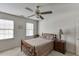 Bedroom with neutral carpet, a ceiling fan, and bright natural light from the white trimmed windows at 711 Belgrave Ln, Tucker, GA 30084
