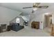 Neutral bonus room with vaulted ceilings, carpet, and a ceiling fan makes this a great flex space at 711 Belgrave Ln, Tucker, GA 30084