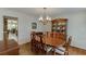 Dining room with a wooden table and china cabinet open to the kitchen at 711 Belgrave Ln, Tucker, GA 30084