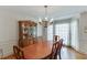 Elegant dining room with a large table, china cabinet, and chandelier at 711 Belgrave Ln, Tucker, GA 30084