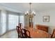 Classic dining room featuring a chandelier, spacious table, and bay windows at 711 Belgrave Ln, Tucker, GA 30084