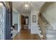 Inviting foyer with hardwood floors, a staircase, and decorative lighting at 711 Belgrave Ln, Tucker, GA 30084