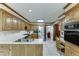 Spacious kitchen with stainless fridge, modern countertop, and classic wood cabinets at 711 Belgrave Ln, Tucker, GA 30084