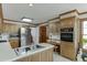 Bright kitchen featuring stainless steel refrigerator and adjacent breakfast nook at 711 Belgrave Ln, Tucker, GA 30084