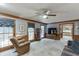 Bright living room with large windows, ceiling fan and classic wood trim at 711 Belgrave Ln, Tucker, GA 30084