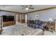 Comfortable living room with ceiling fan, wood trim, and seamless access to other areas at 711 Belgrave Ln, Tucker, GA 30084