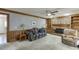 Spacious living room featuring a brick fireplace, ceiling fan, and comfortable seating at 711 Belgrave Ln, Tucker, GA 30084