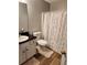 Bright bathroom featuring a toilet, vanity, and tub with a colorful polka dot shower curtain at 102 Ashbury Dr, Villa Rica, GA 30180