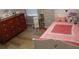 Charming bedroom featuring a playful pink quilt, wood-look floors, and a coordinating dresser at 102 Ashbury Dr, Villa Rica, GA 30180