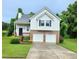 Two-story home boasting an attached two car garage, a well-maintained yard, and a charming front porch at 102 Ashbury Dr, Villa Rica, GA 30180