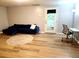 Bright living room featuring a sectional, a desk with chair, and natural light through the door at 102 Ashbury Dr, Villa Rica, GA 30180