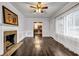 Spacious living room featuring a fireplace, dark wood floors, and an abundance of natural light at 1747 Parkhill Dr, Decatur, GA 30032