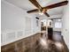Spacious living room with beamed ceiling and wood floors leading to kitchen at 1747 Parkhill Dr, Decatur, GA 30032