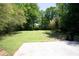 Large, green backyard with lawn area, surrounded by mature trees at 3570 Briar Dr, Lithia Springs, GA 30122