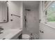 Updated bathroom with white marbled shower, tiled floor, and vanity at 3570 Briar Dr, Lithia Springs, GA 30122