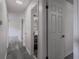 Hallway with hardwood floors and white doors leading to various rooms at 3570 Briar Dr, Lithia Springs, GA 30122