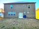 View of the backyard with a house featuring a sliding glass door and several windows at 5150 Amberland Sq, Atlanta, GA 30349