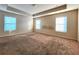 Large carpeted bedroom with tray ceiling and lots of natural light at 5150 Amberland Sq, Atlanta, GA 30349