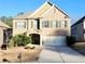 Traditional brick fronted two-story home with a two car garage and well maintained lawn at 5150 Amberland Sq, Atlanta, GA 30349